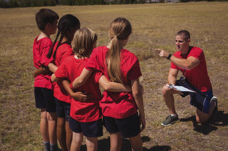 Trainer instructing kids in the boot camp