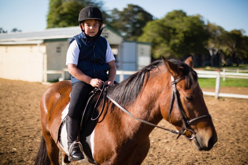Boy riding a horse in the ranch