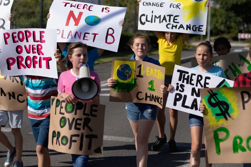 Group of elementary school pupils walking on a protest march