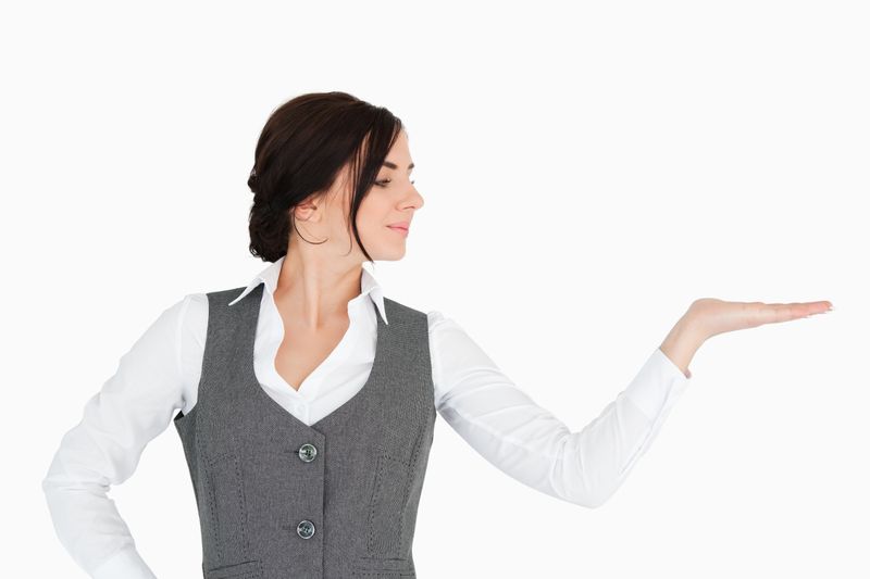 Young businesswoman looking at her palm facing up