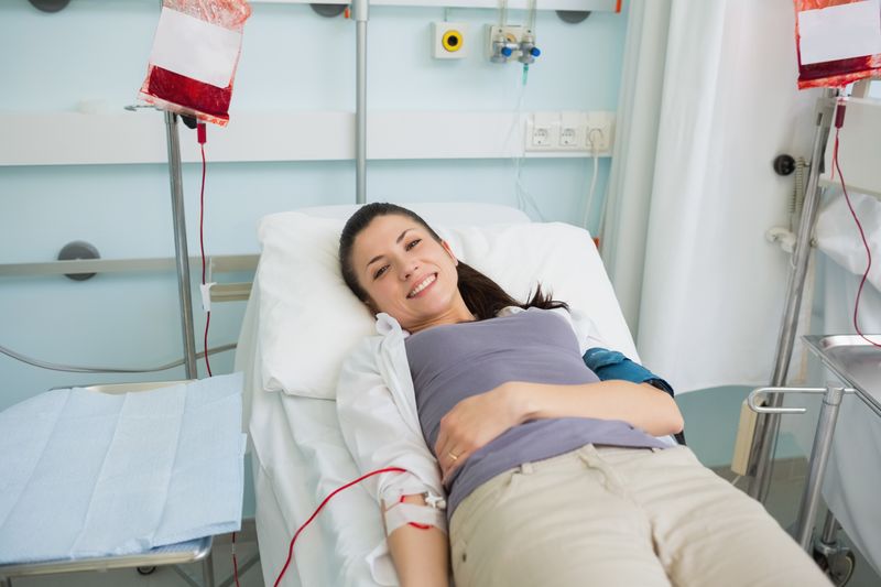 Female transfused lying on a bed