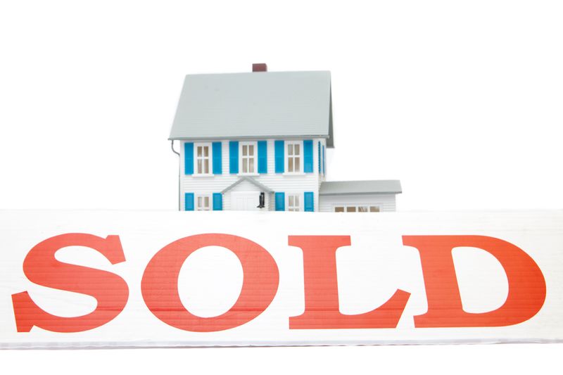 Sold sign in front of house