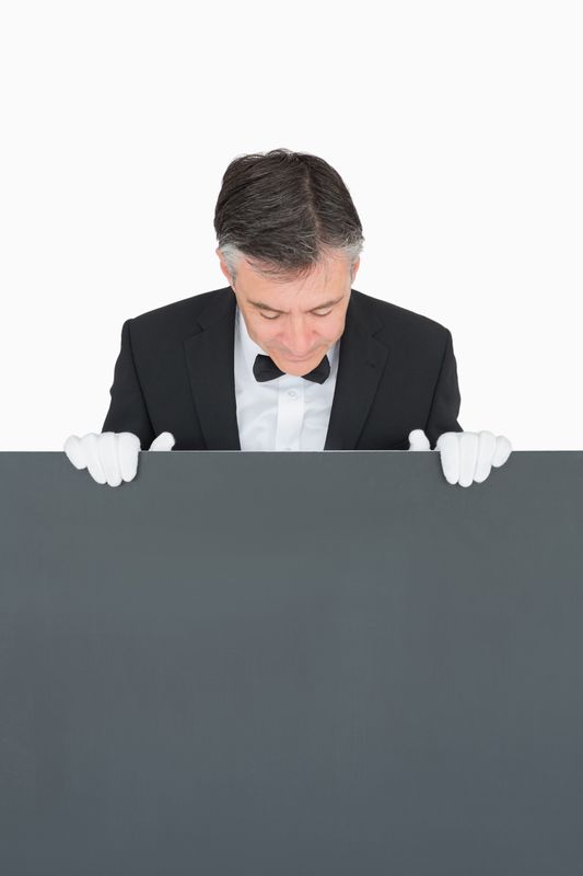 Waiter looking at board before him