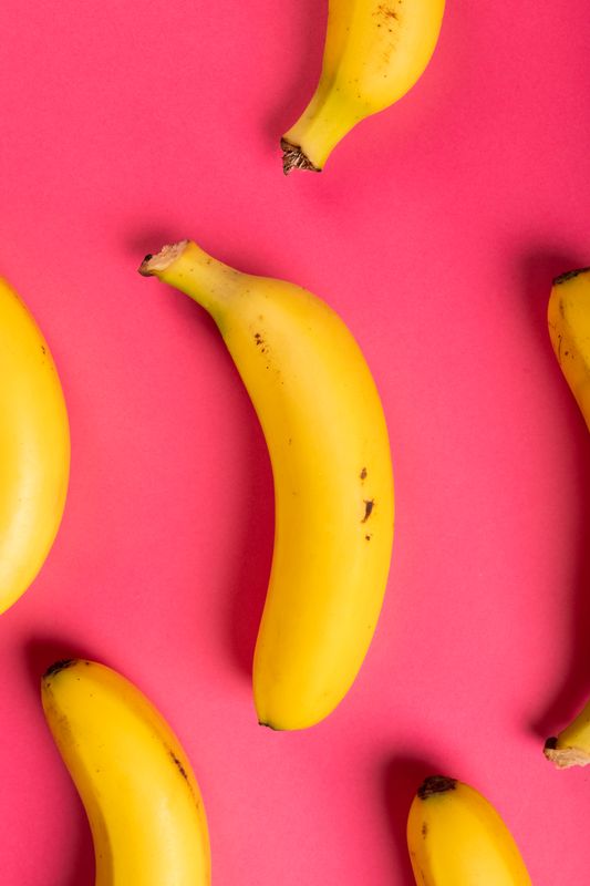 Directly above view of fresh bananas against pink background