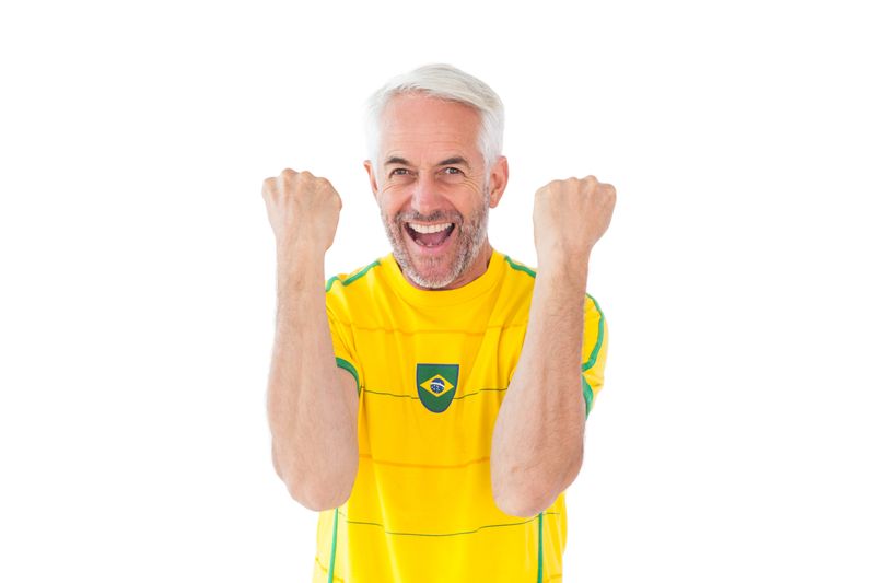 Cheering brazilian football fan in yellow