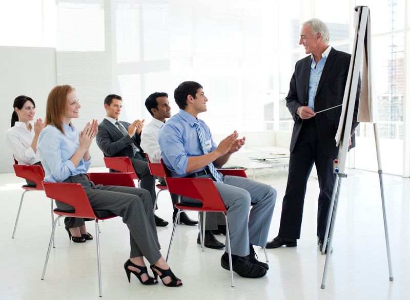 Business people applauding at the end of a conference in the office