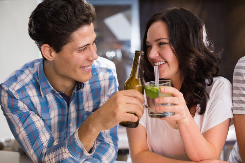 Happy friends having a drink together