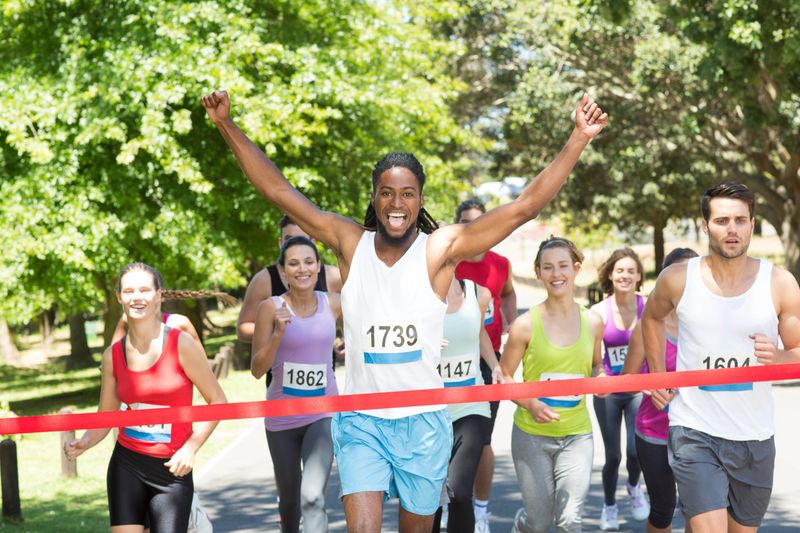 Fit people running race in park on a sunny day