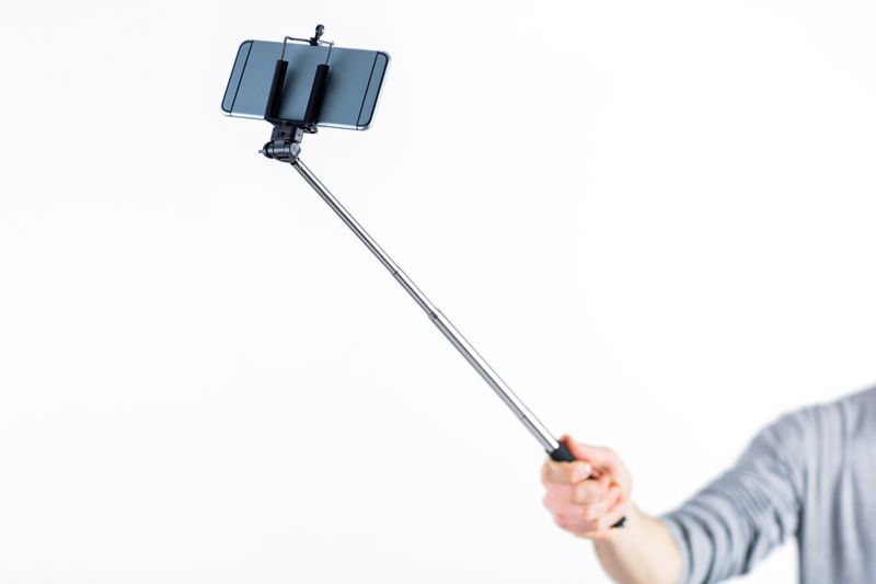 Casual man using a selfie stick