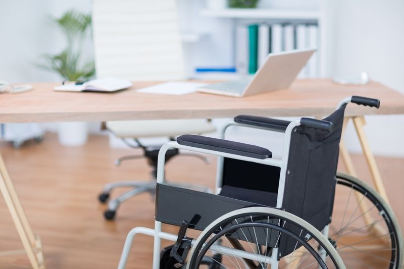 A free wheelchair at his desk 