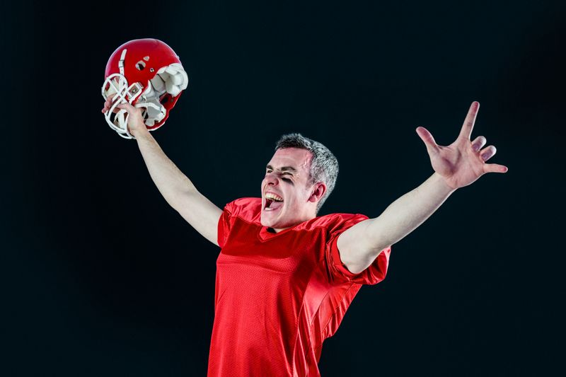 A triumph of an american football player without his helmet 