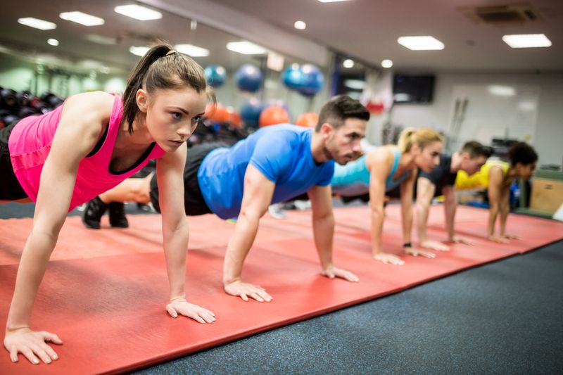 Fit people working out in fitness class at the gym