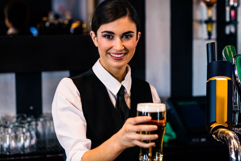 Barmaid serving a pint