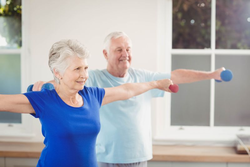 Senior couple performing stretching exercise