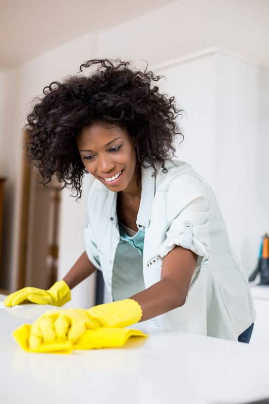 Woman cleaning kitchen counter 