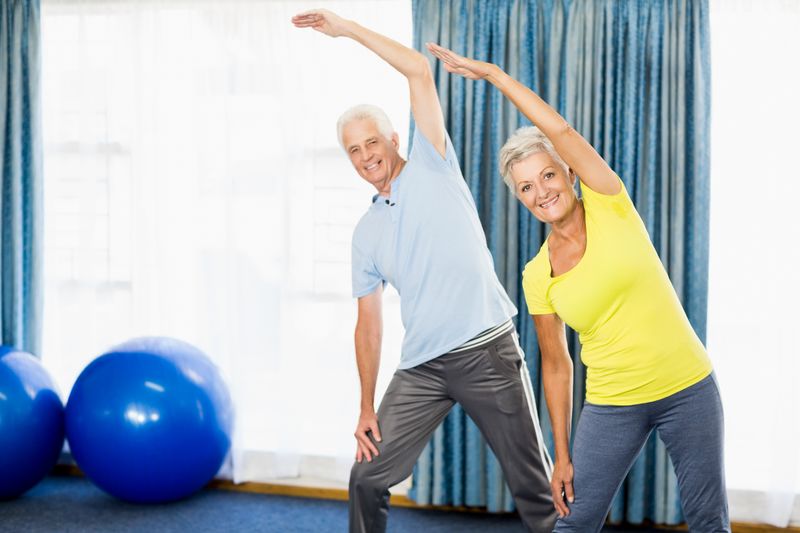 Seniors doing sport exercises in a sport studio