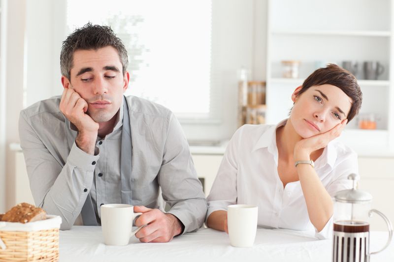 Bored couple drinking coffee