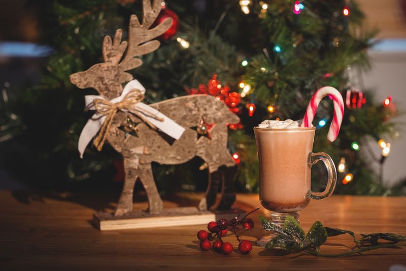 Cup of coffee and christmas decoration on wooden table