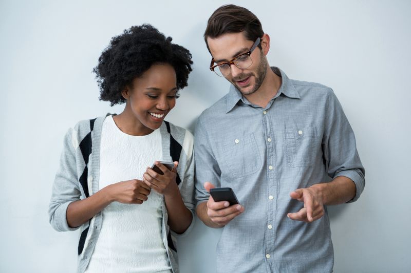 Man and woman using mobile phone