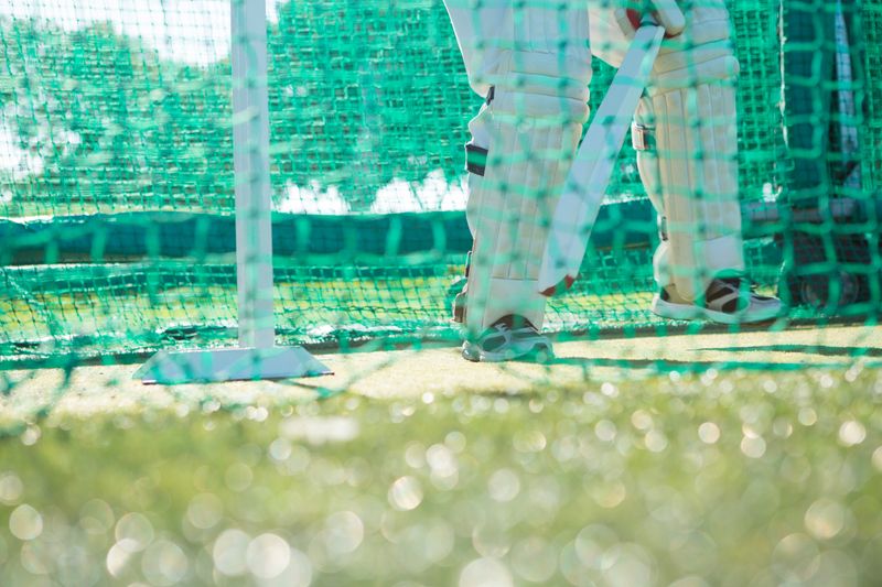 Low section of man playing cricket