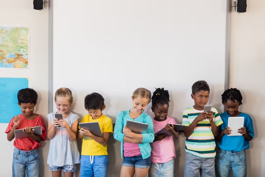Image of children standing and watching videos on their tablets - Meaning and use of hero image in web design - Image