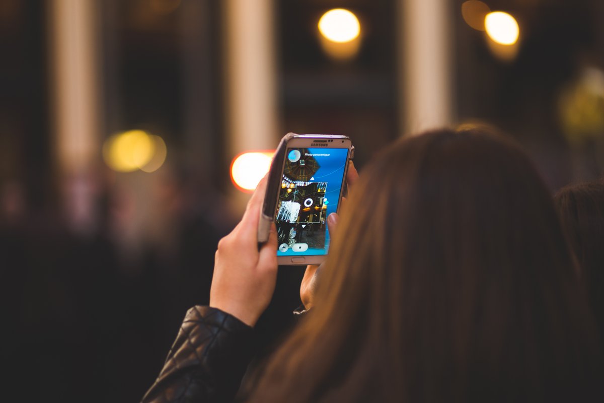 Image of a woman taking pictures - Top relevant social media trends you should know - Image