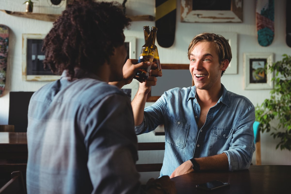Two friends smiling while having a drink - Retail marketing strategy tips and tricks to drive sales and save money - Image
