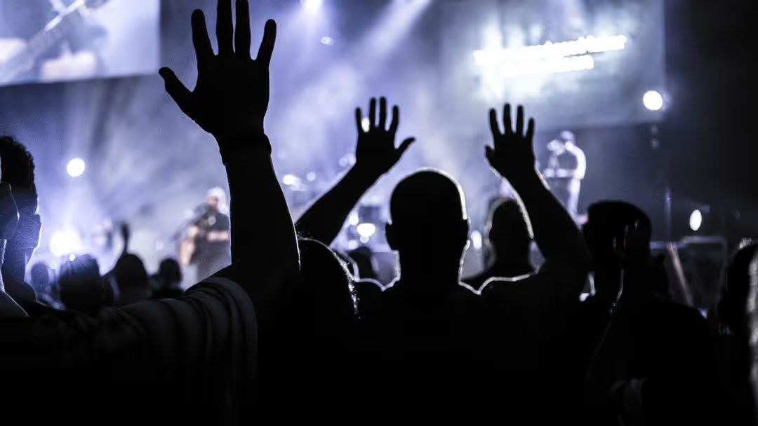 Image of people with raised hands at a concert - A selection of great images for virtual Zoom backgrounds from the PikWizard team - Image