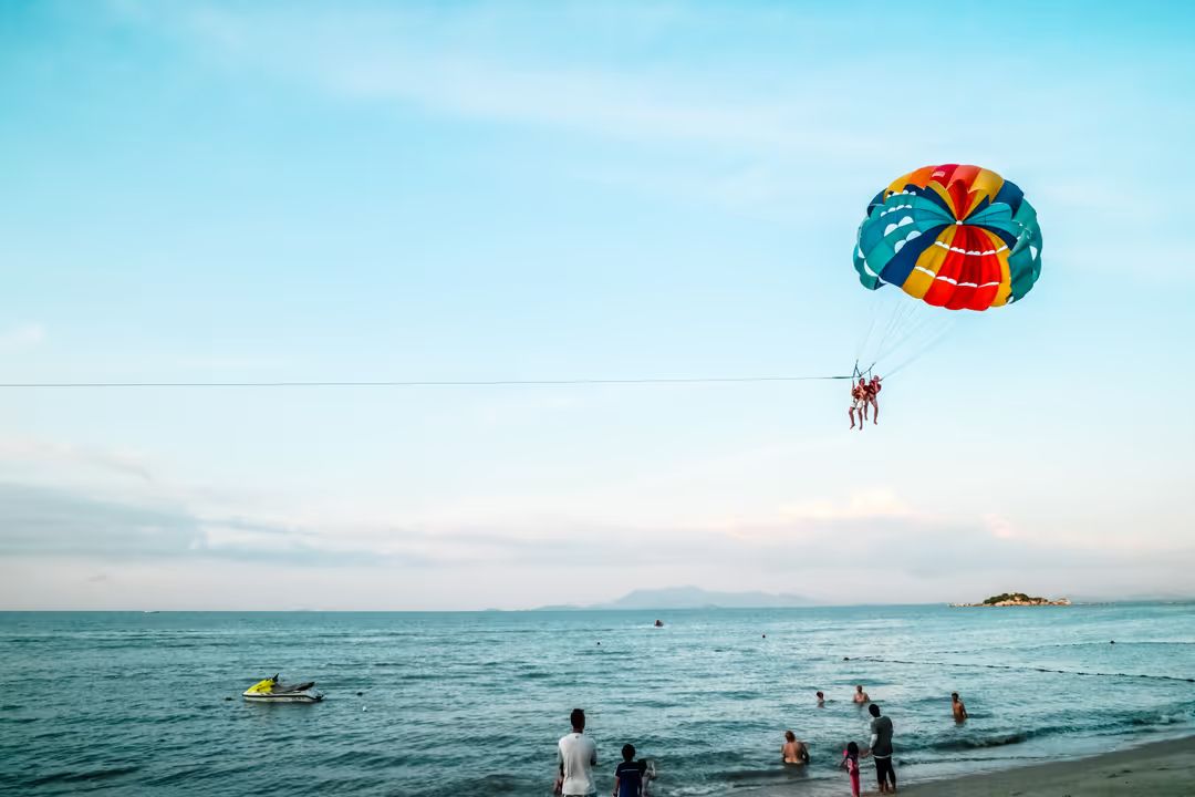 Image of a beach with people and a jetski in the background - A selection of great images for virtual Zoom backgrounds from the PikWizard team - Image