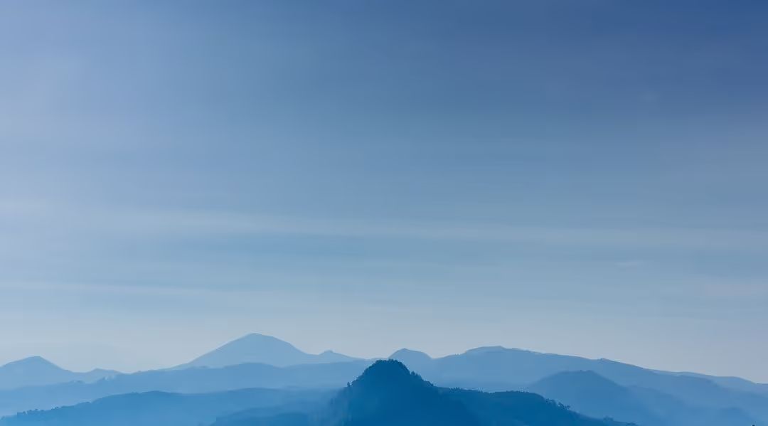 Landscape image of blue mountain tops with a blue sky in the background - How to choose a good color combination for photography - Image