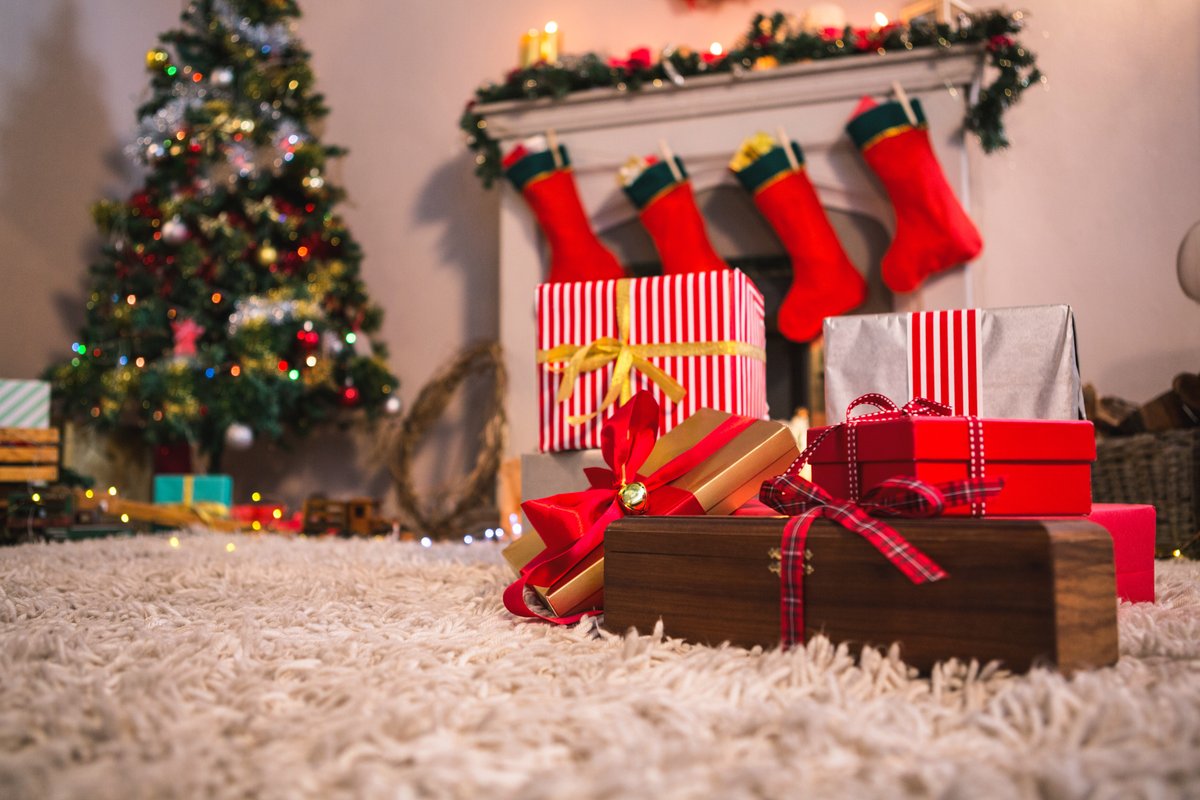 Image of a Christmas tree with presents near the fireplace - A selection of interesting Christmas images from the PikWizard team - Image