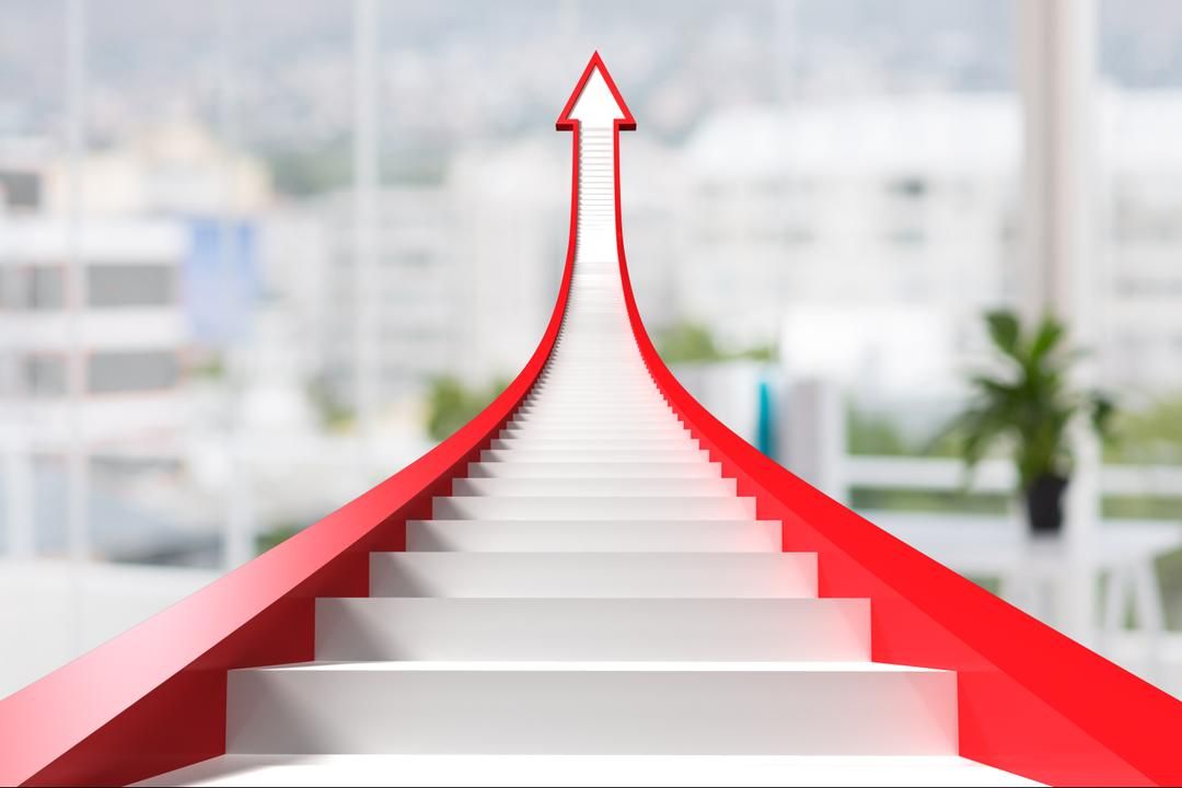 Stairs going up in the shape of an arrow with blurred office background - 15 essential graphic design tips from the experts for industry beginners - Image