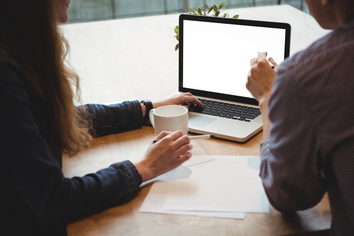 Image of two people working on a laptop together - Six types of graphics you need to know for business marketing - Image