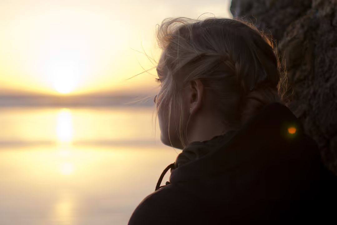 Image of a woman looking into the distance at sunset - Stay inquisitive - Image