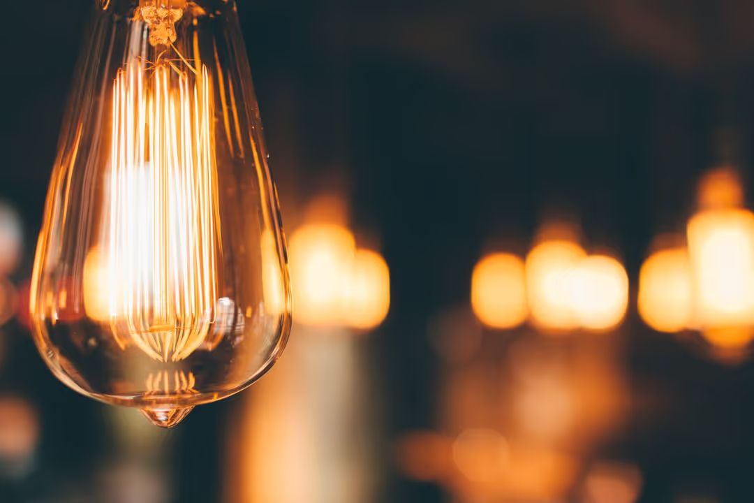 Image of a light bulb with blurred light in the background - A selection of on trend background ideas for your next design - Image