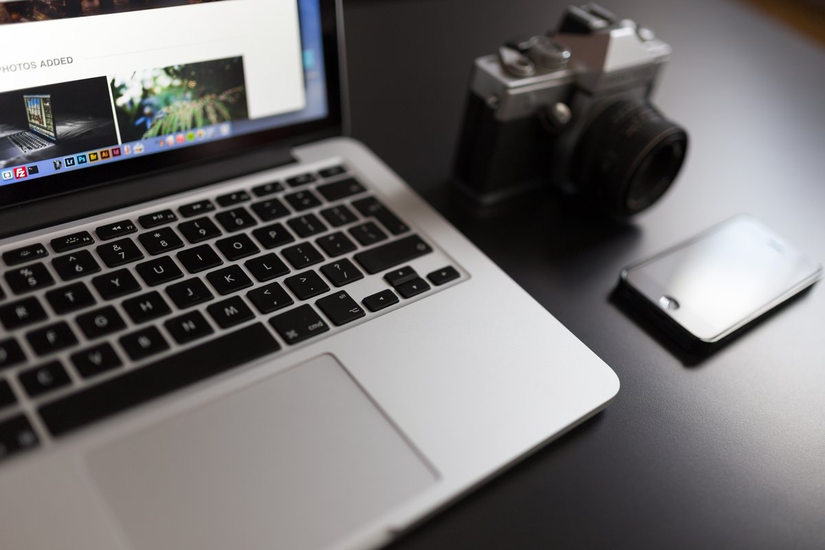 Image of a laptop, a camera and a smartphone on a desk - A selection of great images for virtual Zoom backgrounds from the PikWizard team - Image