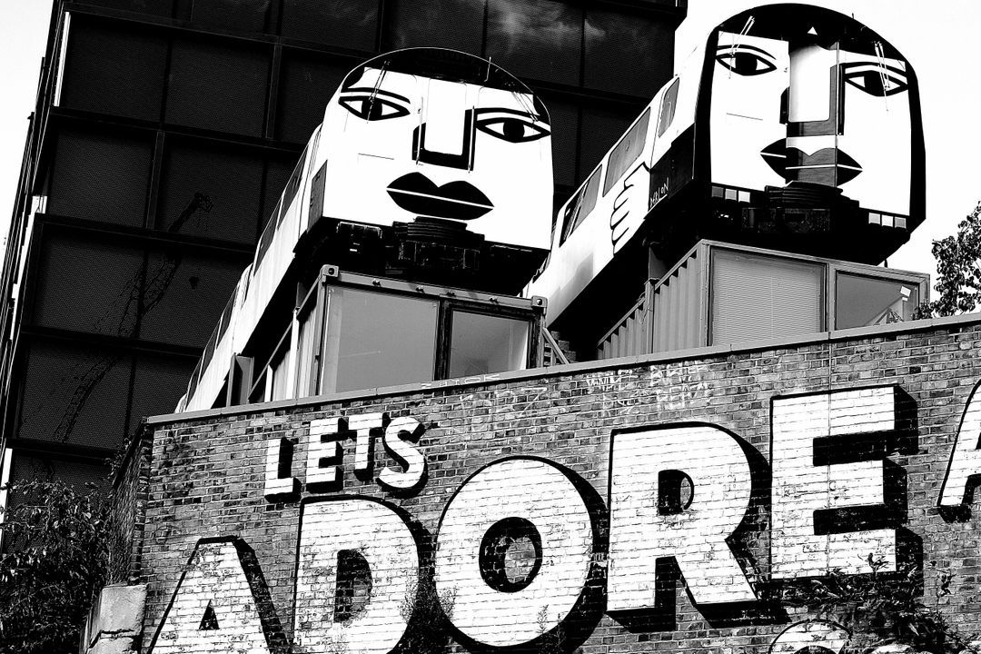 Black and white image of graffiti saying "Let's adore" on a wall - A selection of on trend background ideas for your next design in 2021 - Image