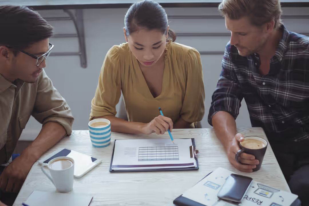 Image of a creative team of three sitting at a table and planning - How to prepare an outline for your content - Image