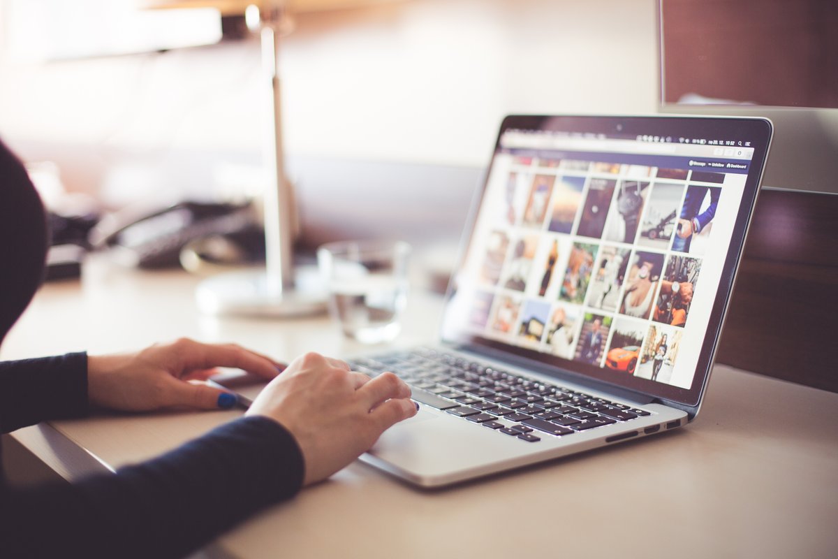Picture of a woman working on her laptop - Collect and analyze data before you begin developing your social media strategy - Image