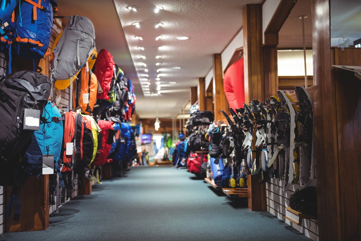 Interior of a sportswear store with backpacks and equipment - Retail marketing strategy tips and tricks to drive sales and save money - Image