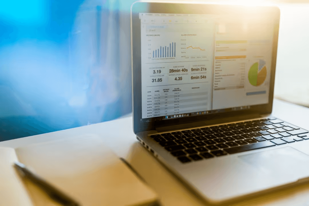 Laptop on a desk with data and analytics on screen - Retail marketing strategy tips and tricks to drive sales and save money - Image