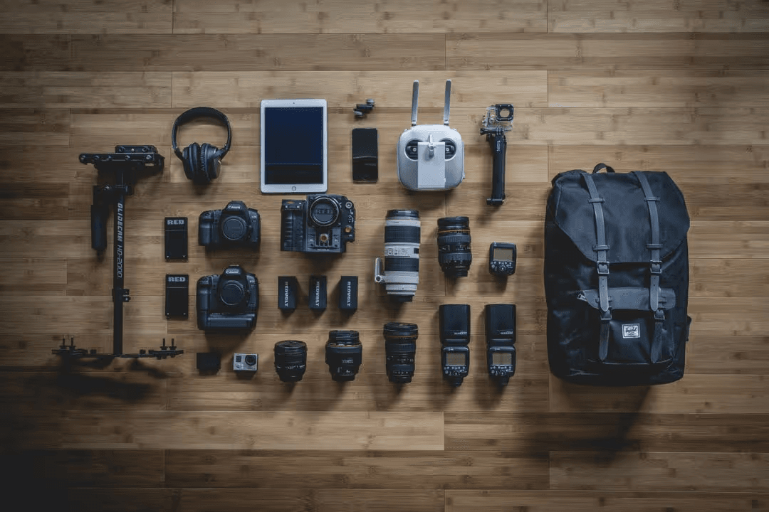 Overhead image of a selection of cameras and photography equipment, comparing the technology - 35 creative YouTube video ideas when you're out of inspiration - Image