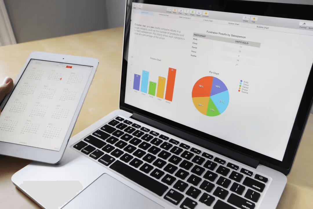 Laptop and tablet with graphics on the screen - Retail marketing strategy tips and tricks to drive sales and save money - Image