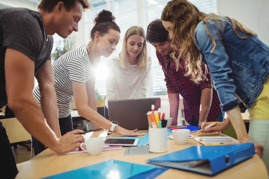 Image of business colleagues discussing sticky notes seen through the glass - Tips on how to plan your business's marketing goals - Image