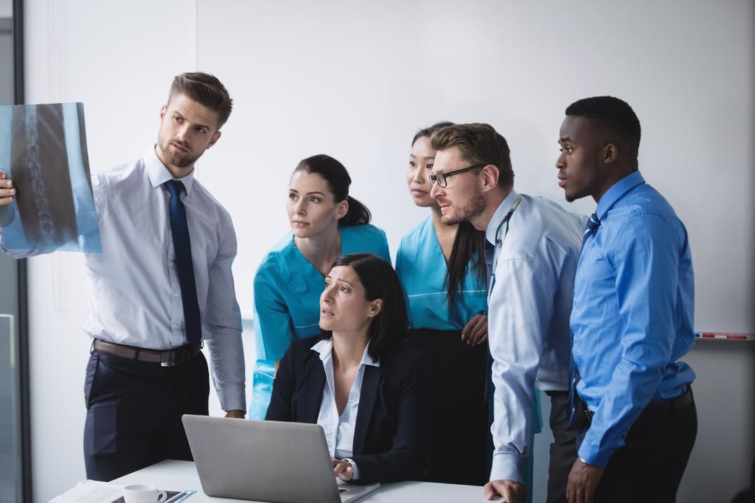Image of graphic designers at a meeting - Tips on how to build a social media team - Image