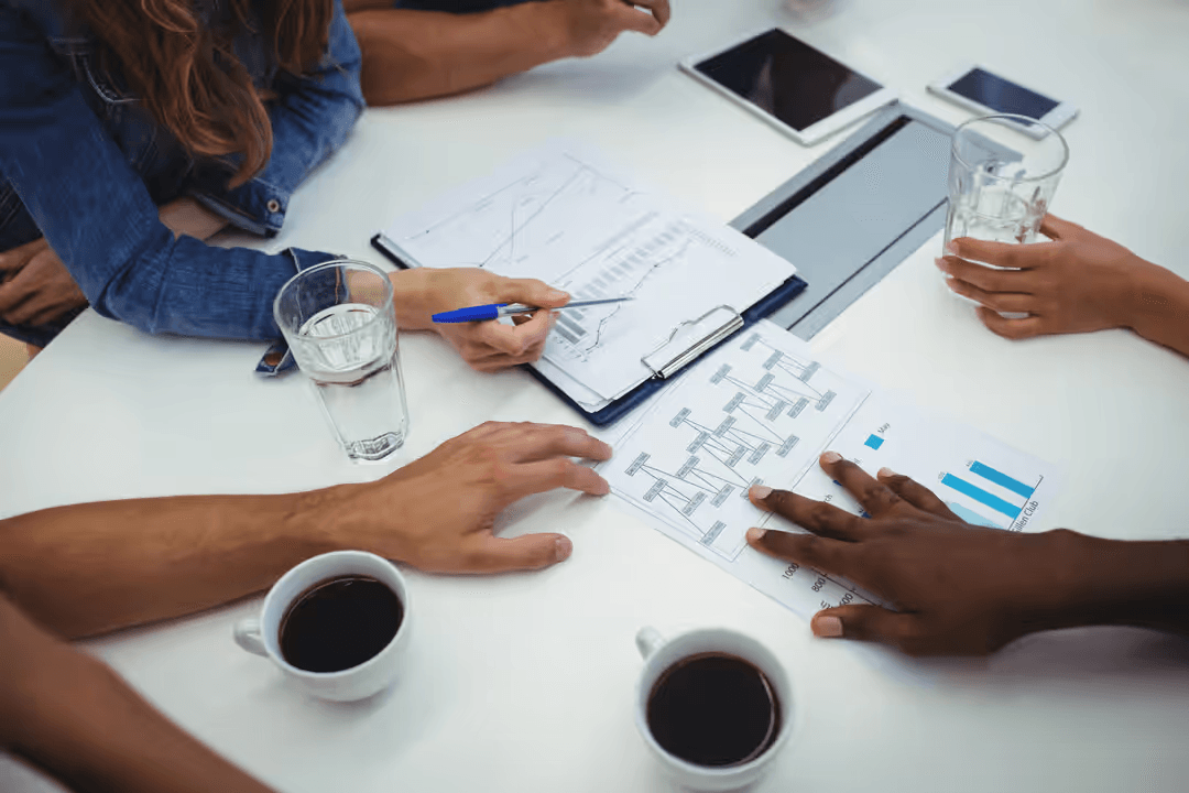 Image of business associates discussing bar charts and trends - Expert online marketing tips to improve your digital strategy and make more money - Image
