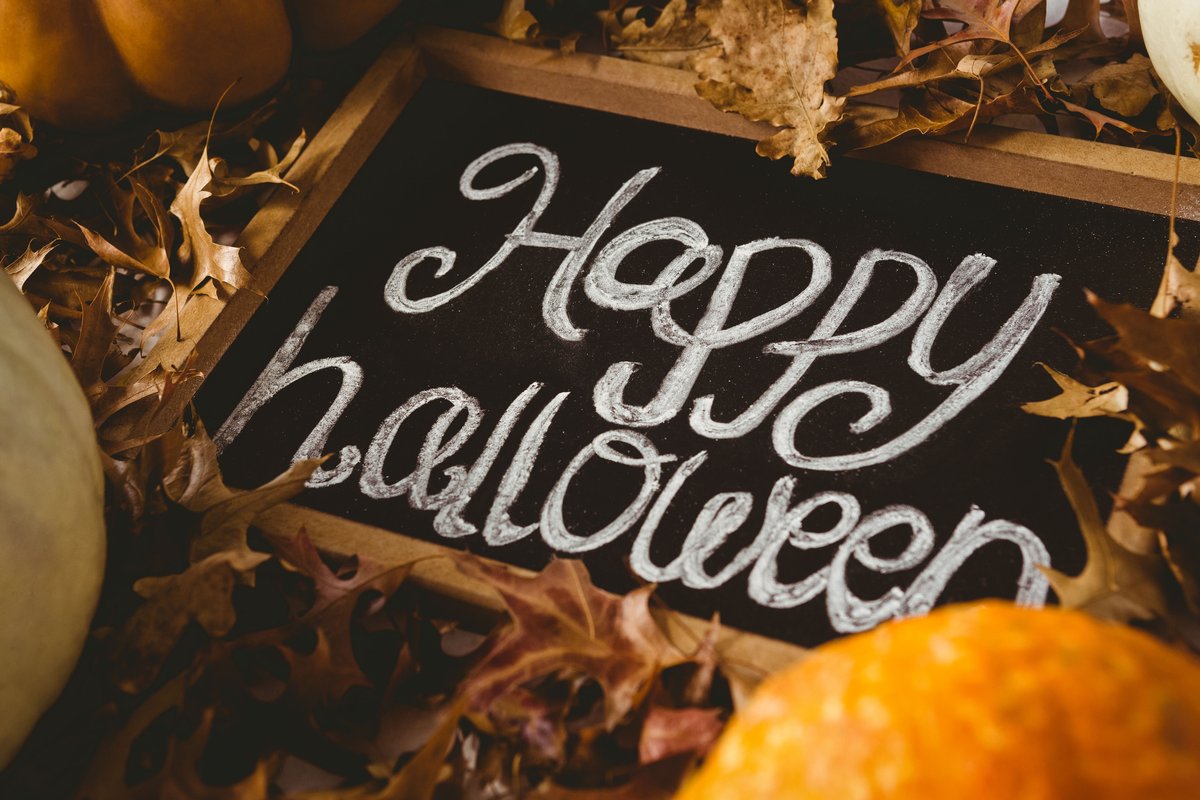 Image of a board on which "Happy Halloween" is written in chalk - A selection of engaging Halloween images from the PikWizard team - Image