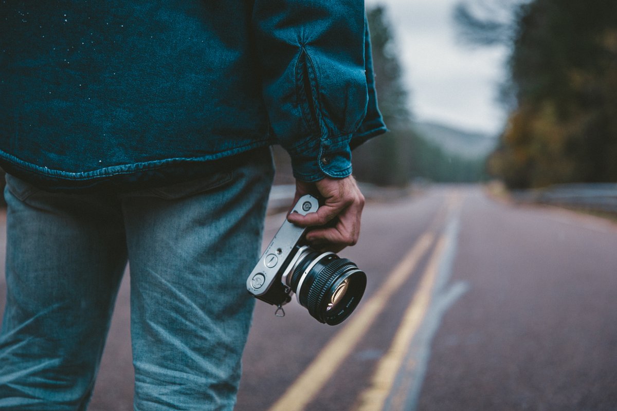 Image of a person holding a camera in one hand - A beginner's guide to royalty-free content - Image
