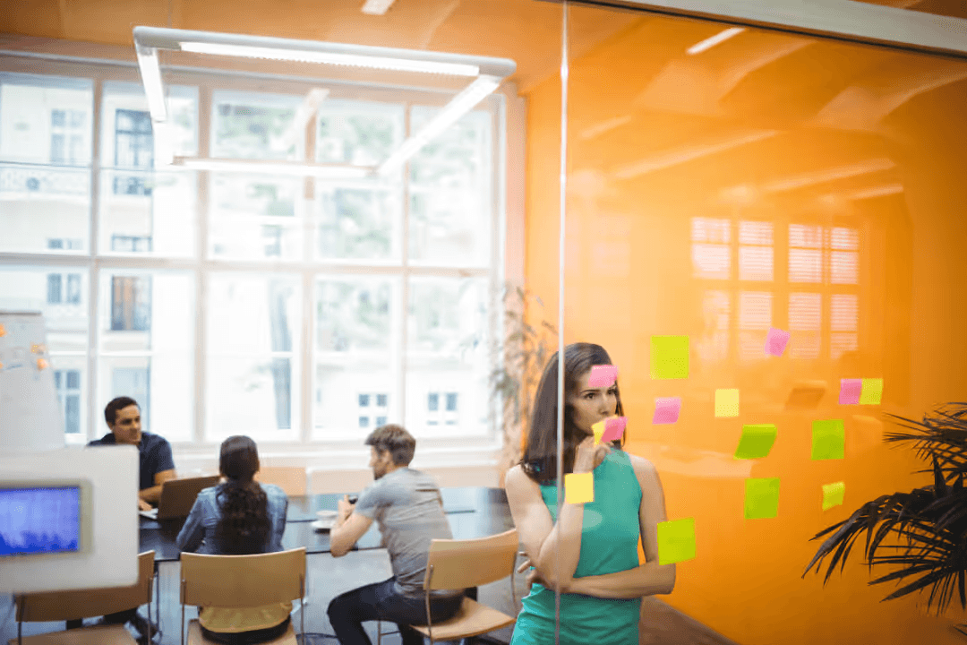 Image of a woman reading sticky notes at the office - The importance of audience personas in marketing - Image
