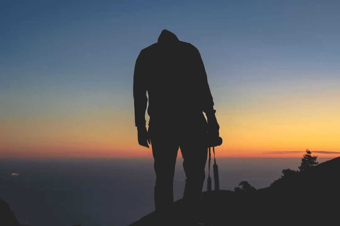 Image of a silhouette of man standing in front of a sunset - Registration of copyright for a photograph - Image